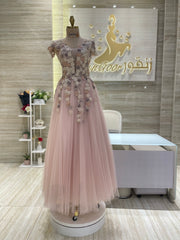 A flowing, sleeveless maxi dress in a soft, shimmering fabric, perfect for a summer evening